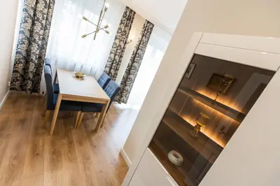 a dining room and living room with a table and chairs at Vintage Krasińskiego 7 Apartments in Kraków