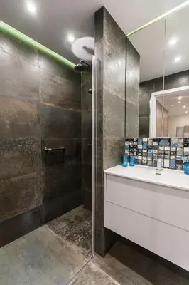 a bathroom with a shower and a sink and a mirror at Vintage Krasińskiego 7 Apartments in Kraków