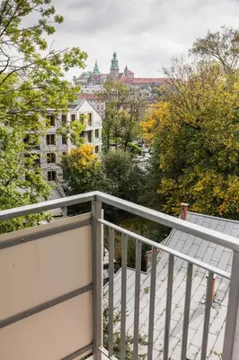 a balcony with a view of a city at Vintage Krasińskiego 7 Apartments in Kraków