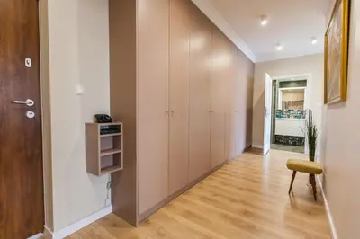 an empty hallway with a closet and a chair at Vintage Krasińskiego 7 Apartments in Kraków