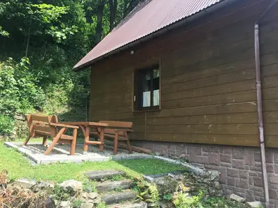 a picnic table and benches in front of a building at domek w centrum w Zawoi in Zawoja