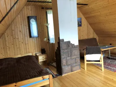a attic room with a bed and a fireplace at domek w centrum w Zawoi in Zawoja