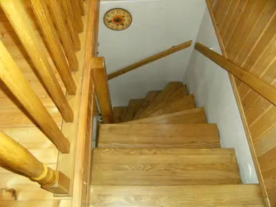 a staircase in a house with a clock on the wall at domek w centrum w Zawoi in Zawoja
