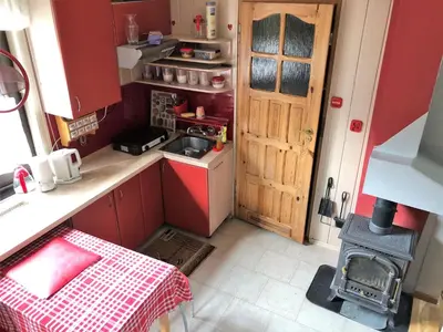 a small kitchen with a sink and a stove at domek w centrum w Zawoi in Zawoja
