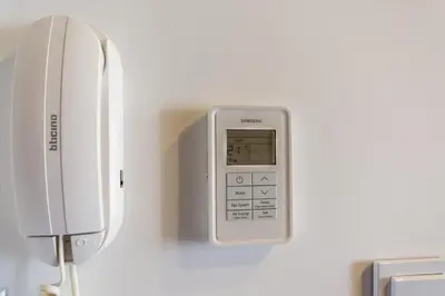 a phone is hanging on a wall at Central balcony apartment - Window on Cracow in Kraków