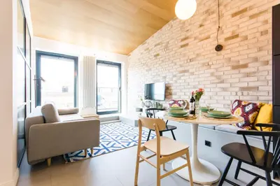 a kitchen with a table and chairs in a room at Central balcony apartment - Window on Cracow in Kraków