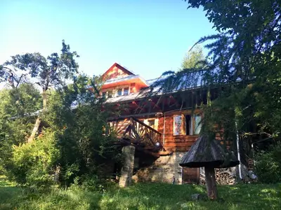 a pile of fire wood next to a door at Chałupa z widokiem w górach in Zawoja