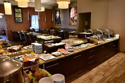 a buffet line with many different types of food at Metropolitan Boutique Hotel in Kraków
