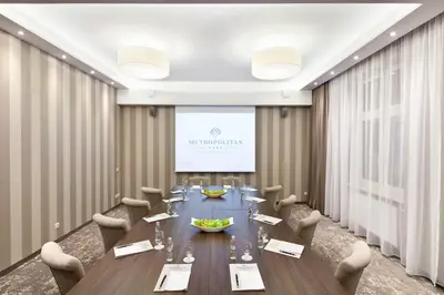 a conference room with a long table and chairs at Metropolitan Boutique Hotel in Kraków