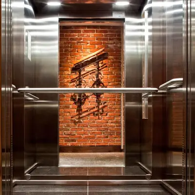 a kitchen with a brick wall and a metal appliance at Metropolitan Boutique Hotel in Kraków