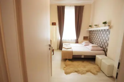a bedroom with two beds and a window at Rainbow Apartments 2 in Kraków