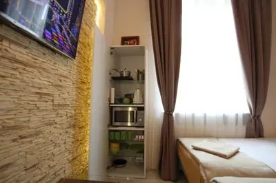 a room with a bed and a brick wall at Rainbow Apartments 2 in Kraków