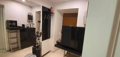 a living room with a flat screen tv in a room at Rainbow Apartments 2 in Kraków