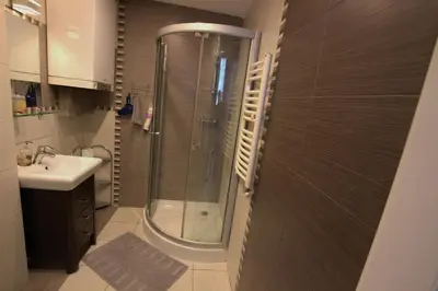 a bathroom with a shower and a sink at Rainbow Apartments 2 in Kraków