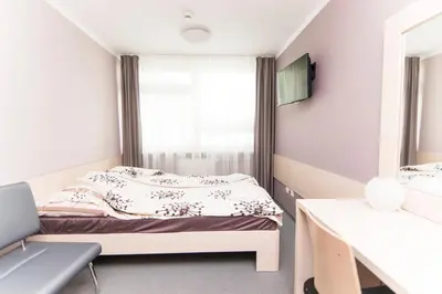 a room with two beds and a mirror at Strumyk in Kraków