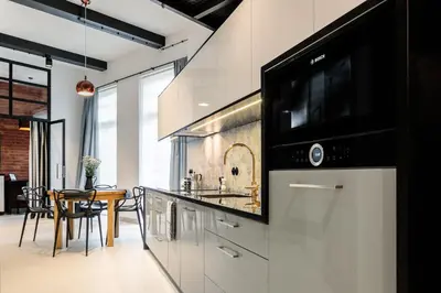 a kitchen with a sink and a microwave at 3D WYGODA Apartamenty in Kraków