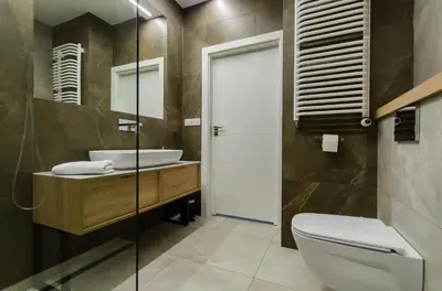 a bathroom with a toilet and a sink at Krakowiak Apartments in Kraków