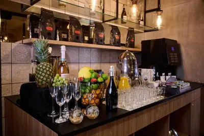 a bar with wine glasses and fruit on a counter at Hotel M29 in Kraków