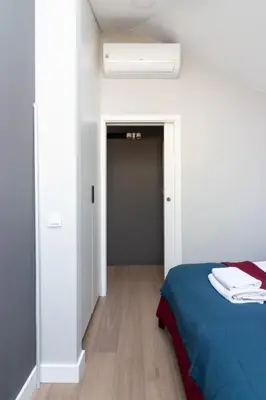 a bedroom with a blue bed and a closet at Apartment NEARTO Old Town Miodowa Parking in Kraków