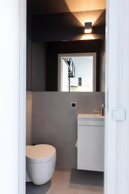 a bathroom with a white toilet and a sink at Apartment NEARTO Old Town Miodowa Parking in Kraków