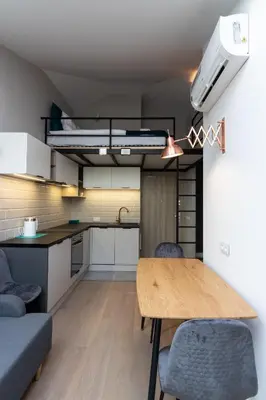 a kitchen and dining room with a table and chairs at Apartment NEARTO Old Town Miodowa Parking in Kraków