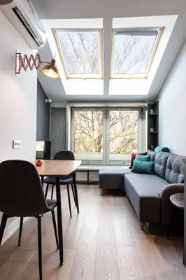 a living room with a couch and a table and windows at Apartment NEARTO Old Town Miodowa Parking in Kraków