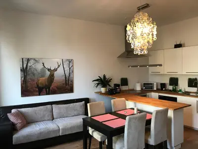 a living room with a couch and a table with a deer painting at Apartament Galicja in Chrzanów