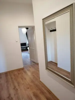 an empty room with a mirror and a hallway at Apartament Galicja in Chrzanów