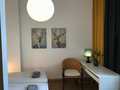 a room with a desk and three paintings on the wall at Apartament Galicja in Chrzanów