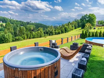 a large hot tub on a patio with a yard at Villa in Nowy Targ with Mountain Views & Pool in Nowy Targ