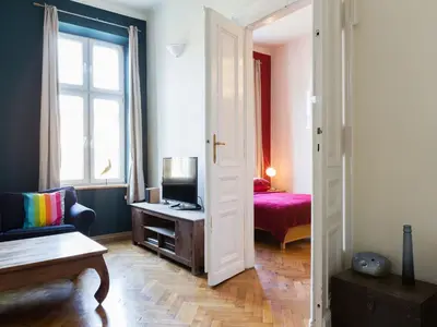 a room with a door open to a room with a bedroom at Apartment in Krakow near Main Square in Kraków