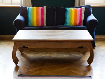 a black couch with colorful pillows and a coffee table at Apartment in Krakow near Main Square in Kraków