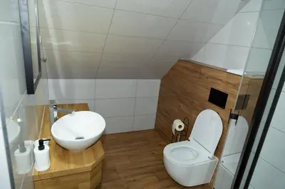 a small bathroom with a toilet and a sink at Zajazd u ELiZY in Czajowice