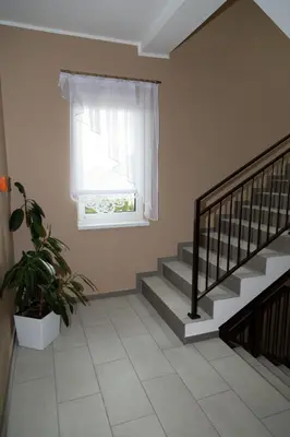 a staircase in a house with a window and a plant at Zajazd u ELiZY in Czajowice