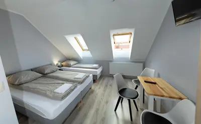 a small room with a bed and a table at Zajazd u ELiZY in Czajowice