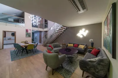 a living room with a couch and chairs and a table at Natura Villa Spa in Węgrzce