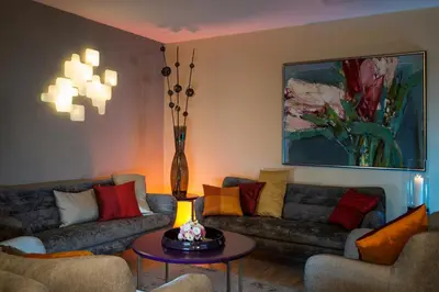 a living room with two couches and a table at Natura Villa Spa in Węgrzce