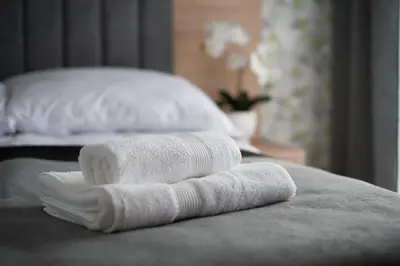two white towels sitting on top of a bed at Willa-Wita in Kalwaria Zebrzydowska