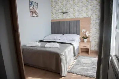 a bedroom with a bed with two towels on it at Willa-Wita in Kalwaria Zebrzydowska