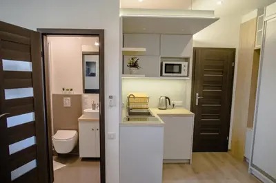 a small kitchen with a sink and a toilet at ULMA studio in Wieliczka