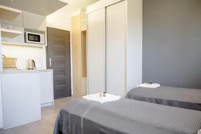 a hotel room with two beds and a kitchen at ULMA studio in Wieliczka