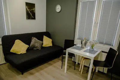 a living room with a black couch and a table at ULMA studio in Wieliczka