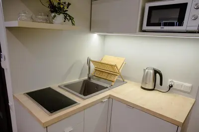 a small kitchen with a sink and a microwave at ULMA studio in Wieliczka