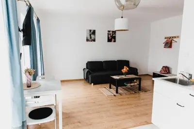a living room with a black couch and a table at Joanna in Kraków