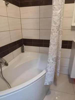 a kitchen with white cabinets and a table in a room at Joanna in Kraków