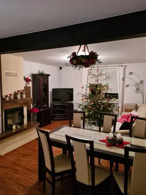 a living room with a table and a christmas tree at Zielona willa in Rabka
