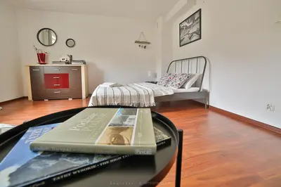 a living room with a glass table with a book on it at Zielona willa in Rabka