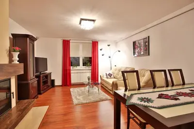 a living room with a couch and a table at Zielona willa in Rabka