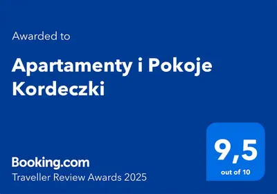 a dining room with a table and chairs and a clock at Apartamenty i Pokoje Kordeczki in Rabka