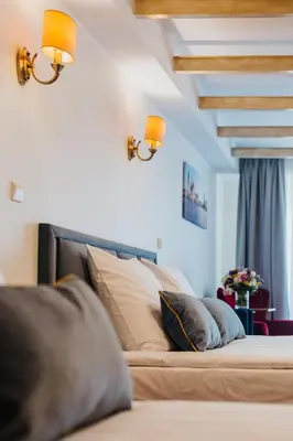a bed with pillows on it in a room at Hotel Jan in Kraków